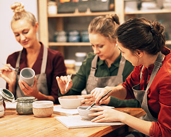 cheerful-females-painting-ceramics