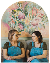 Korryn Swindail-Hill and Christina Esdaile talking on lounge